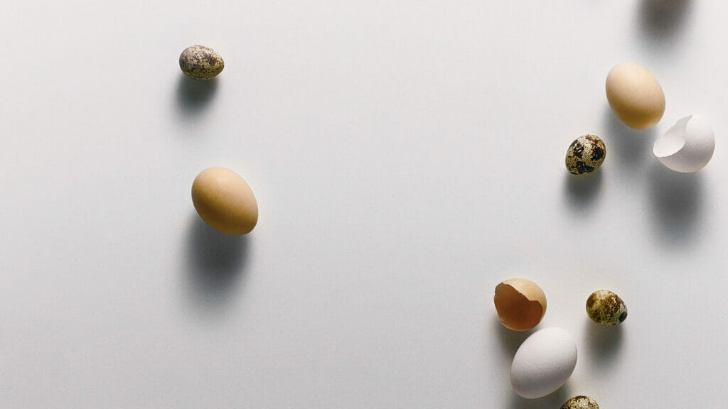 Eggs on a smooth, immaculate pure white surface, showcasing a clean and elegant canvas for culinary display.