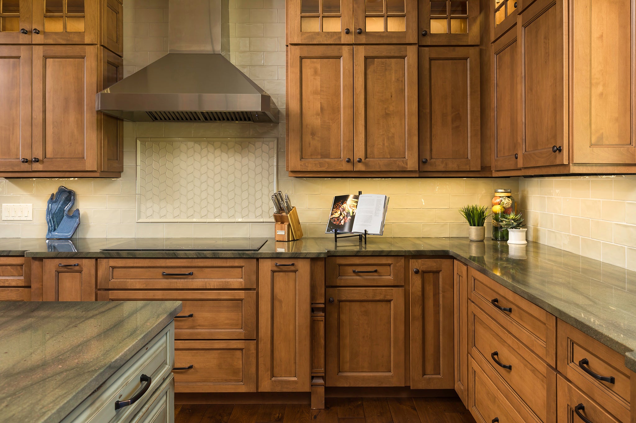 Customizable Shiloh cabinets in a modern kitchen with wood finish and stylish accents.