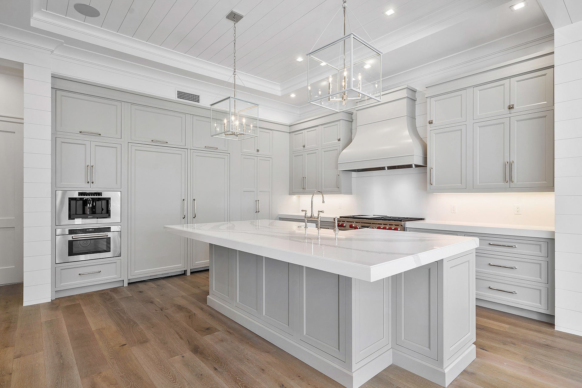 Modern kitchen featuring Shiloh cabinets in a customizable design with gray wood finish and elegant lighting.