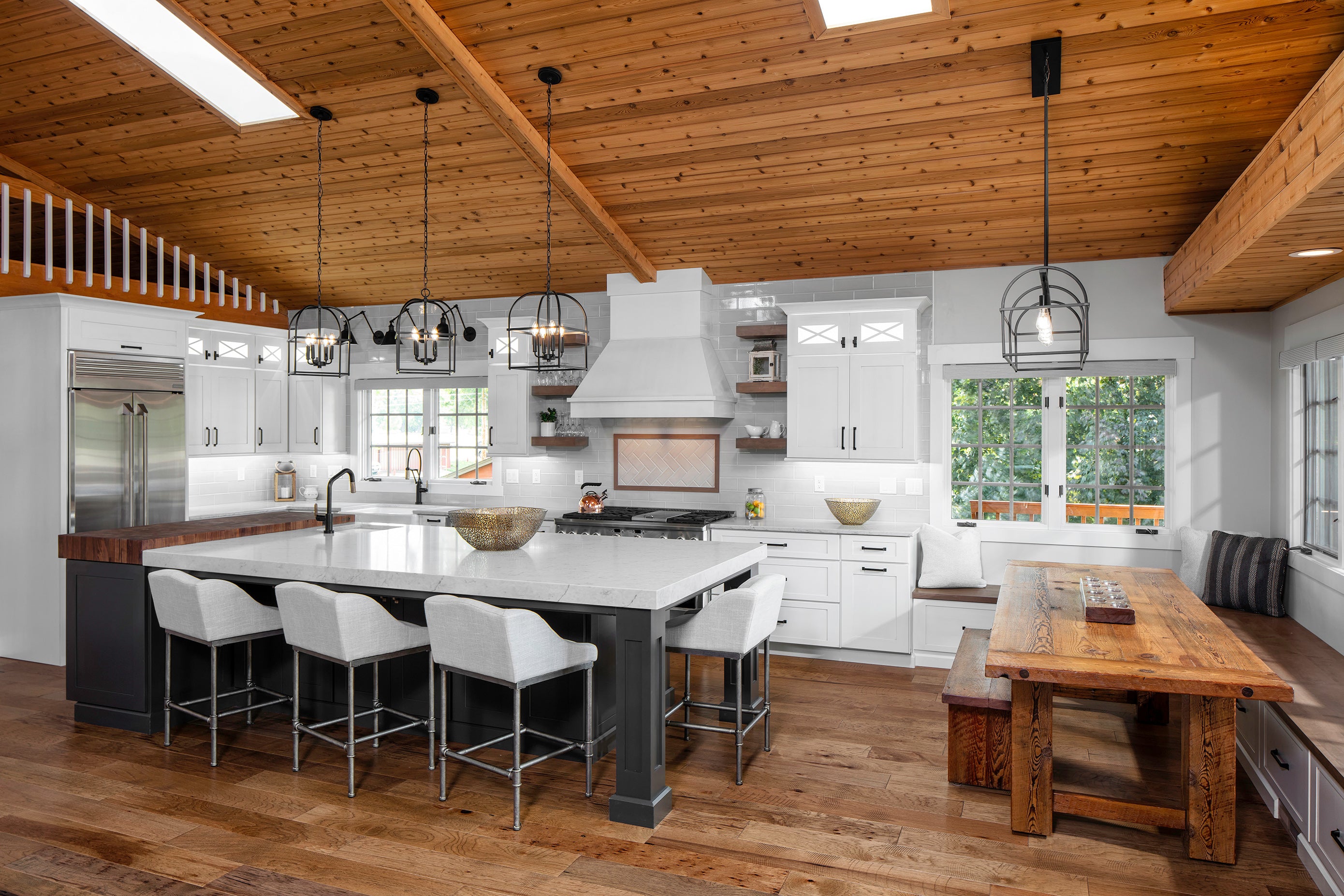 Modern kitchen featuring Shiloh cabinets, a large island, and natural wood accents for a custom design.
