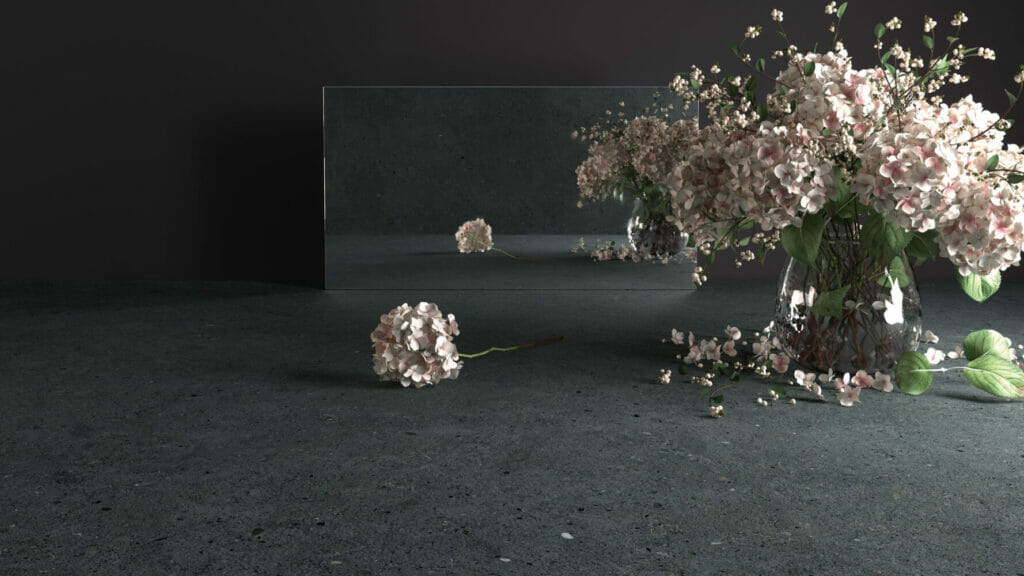 Vase with pink flowers on a slate-inspired surface, reflecting in a mirror, creating a calm and fresh aesthetic.