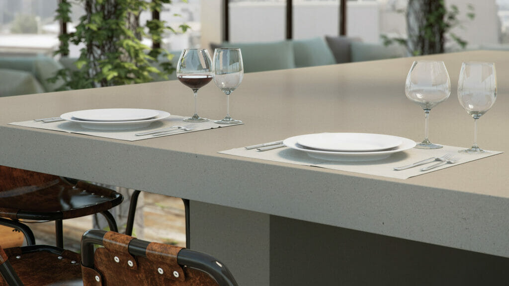 Modern dining setup featuring a 4004 Raw Concrete table with plates and wine glasses, showcasing urban aesthetics.
