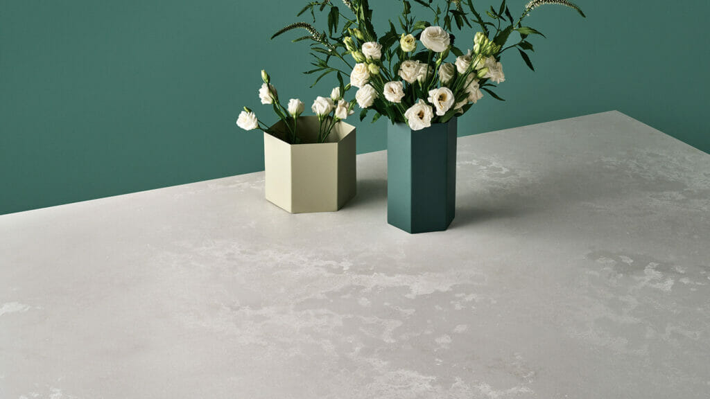 Elegant 4011 Cloudburst Concrete surface with textured finish, featuring modern vases and fresh flowers.