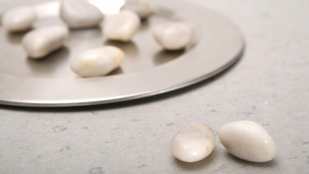 4030 Pebble in ashen shade with quartz chips, featured on a silver plate, enhancing a clean aesthetic.