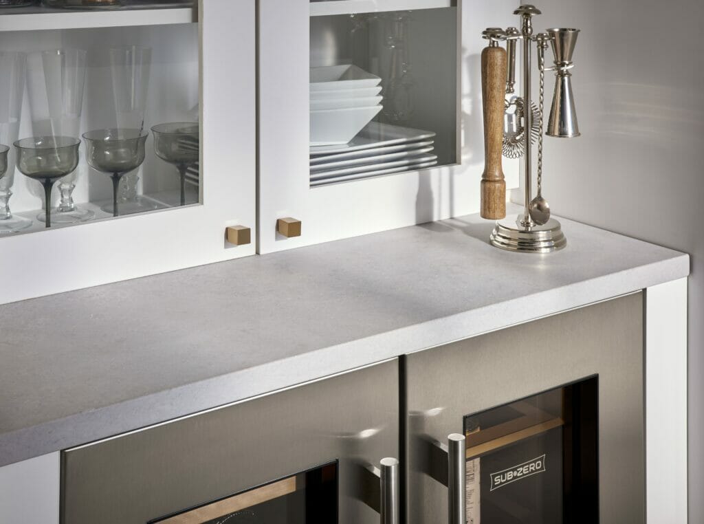 Close-up of a modern kitchen countertop featuring 4044 Airy Concrete with refined texture and elegant kitchen accessories.