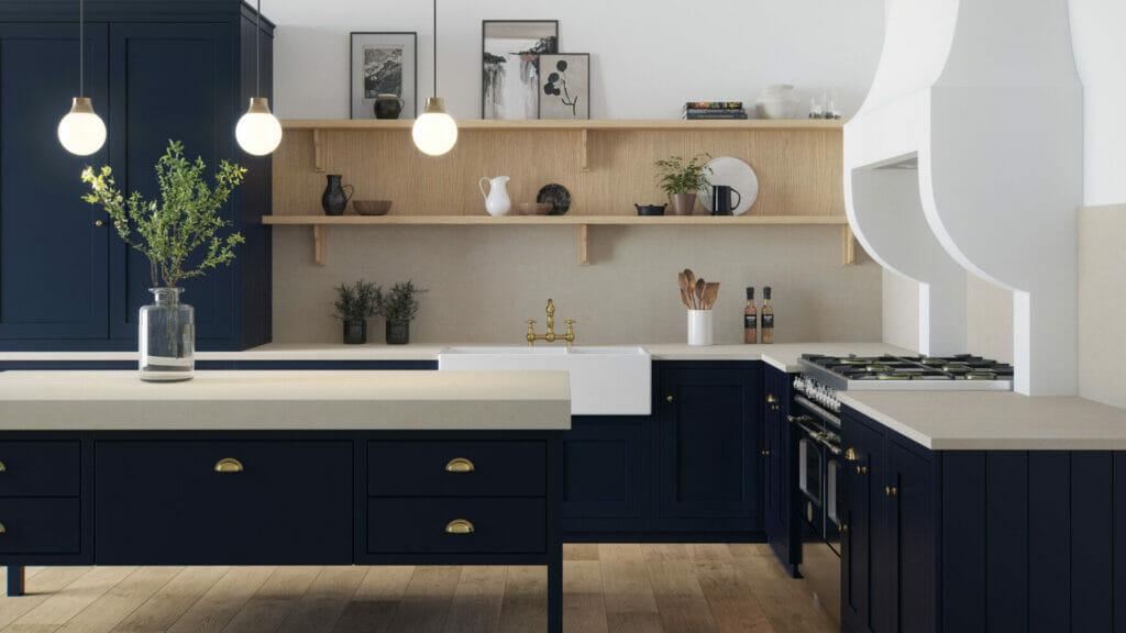 Modern kitchen featuring navy blue cabinets, light wood shelves, and a neutral-toned countertop with elegant lighting.
