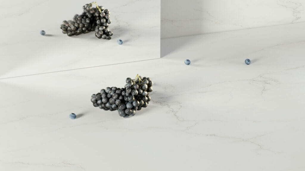 Beautiful pure white surface resembling marble with delicate golden-brown veining, featuring grapes and decorative elements.