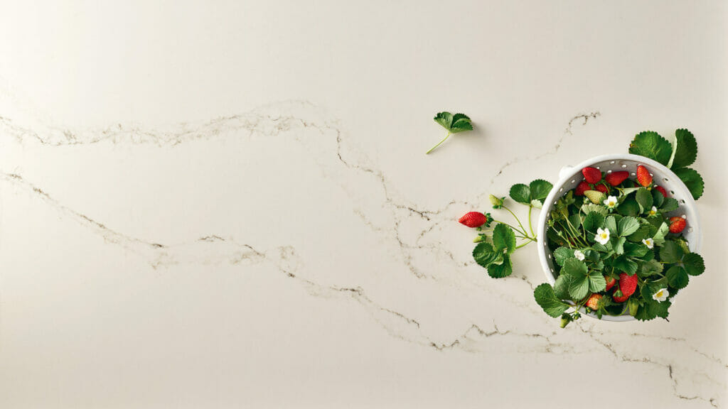 5111 Statuario Nuvo marble countertops with strawberries and greenery, showcasing creamy white with grey and brown veins.