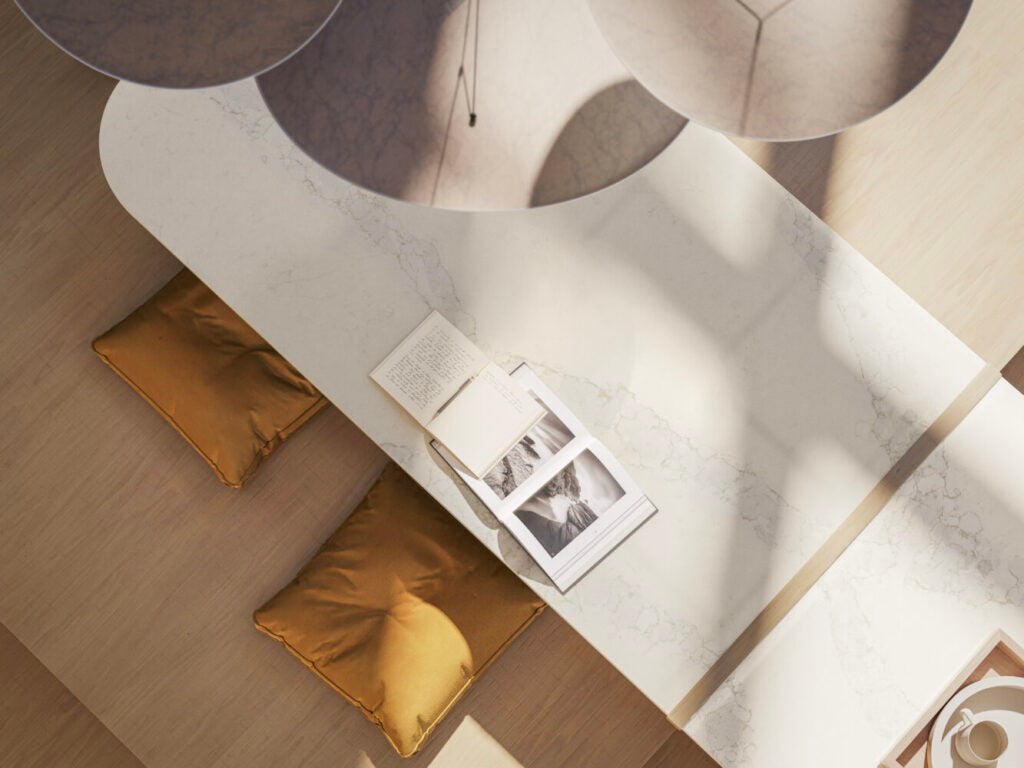 Elegant overhead view of 5115 Calacatta Stillstorm countertop, featuring white base with subtle grey veins and golden accents.