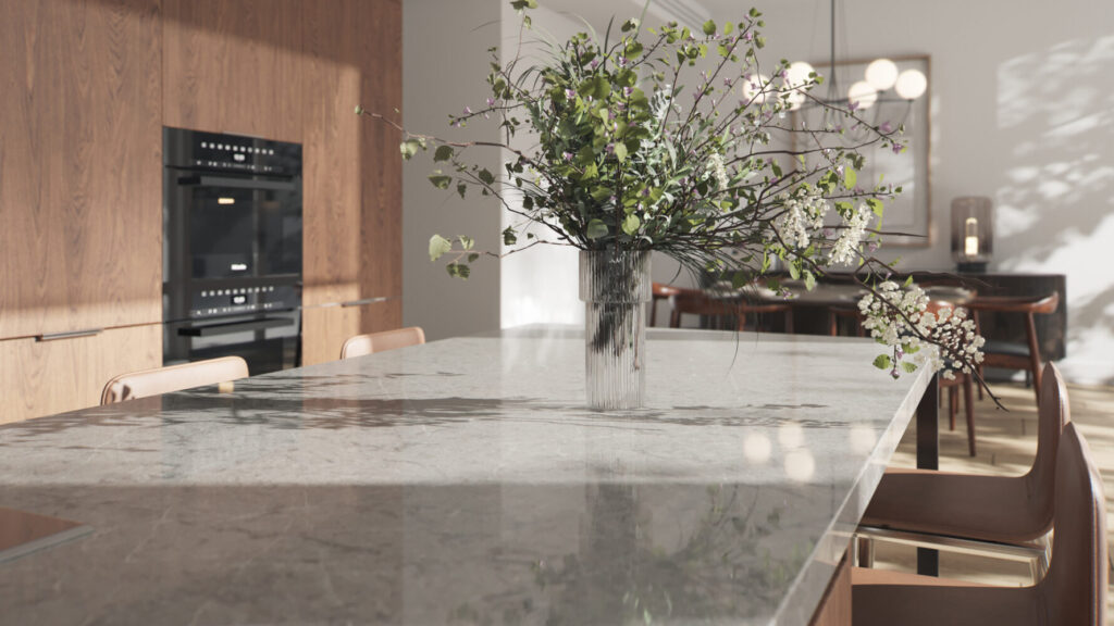 Modern kitchen featuring a Symphony Grey countertop with a decorative vase of greenery, showcasing elegance and design.
