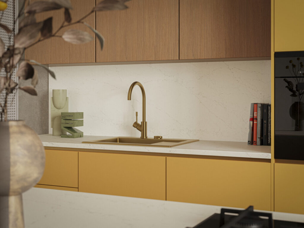 Modern kitchen featuring Dreamy Carrara countertop, brass faucet, wooden cabinets, and stylish decor accents.