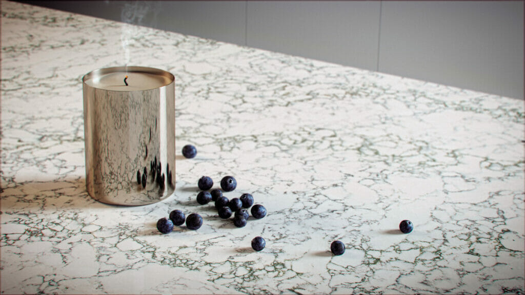 A silver candle on a textured stone countertop with scattered blueberries, showcasing a modern and elegant design.