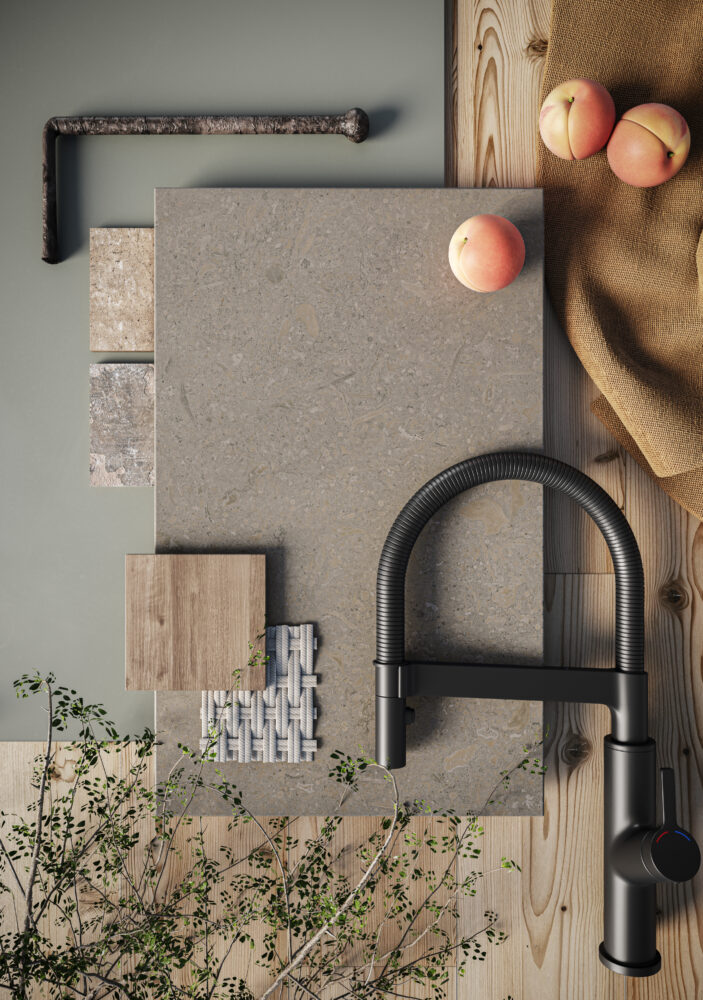 Stylish kitchen scene featuring a modern faucet, neutral grey stone surface, wood accents, and fresh fruit.