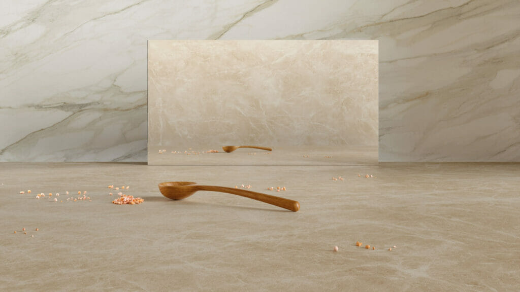 580 Fume slab in honed finish with cream veining and wooden spoon on beige surface, showcasing its elegant marbling.