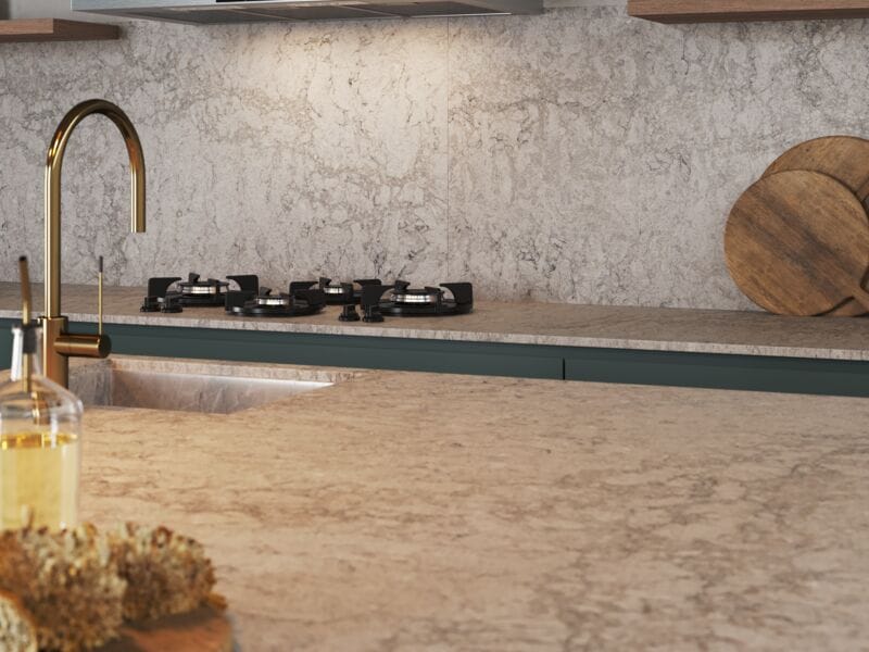 Stylish kitchen featuring 6046 Moorland Fog countertop, with gas stove and wooden cutting boards, showcasing creamy taupe colors.