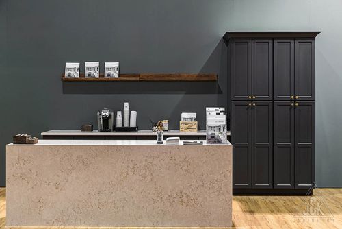 Charcoal cabinetry and marble counter showcasing stylish kitchen design by J&K, featuring solid wood construction.