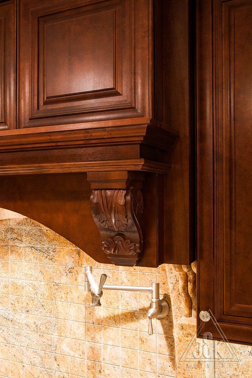 Elegant mahogany kitchen cabinetry with intricate detailing and solid wood construction, showcasing traditional design.