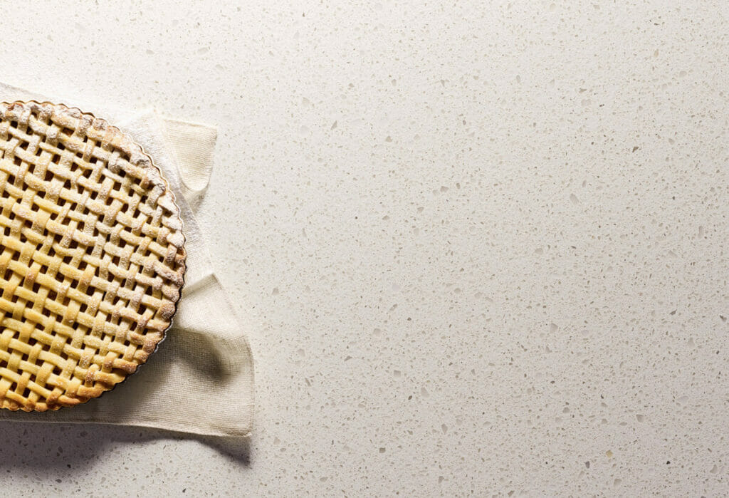 Woven basket on a light, textured surface with neutral tones and a soft cloth underneath.