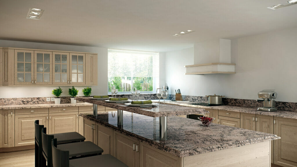 Modern kitchen with light wood cabinets and a granite countertop featuring dramatic grey veining and ample natural light.