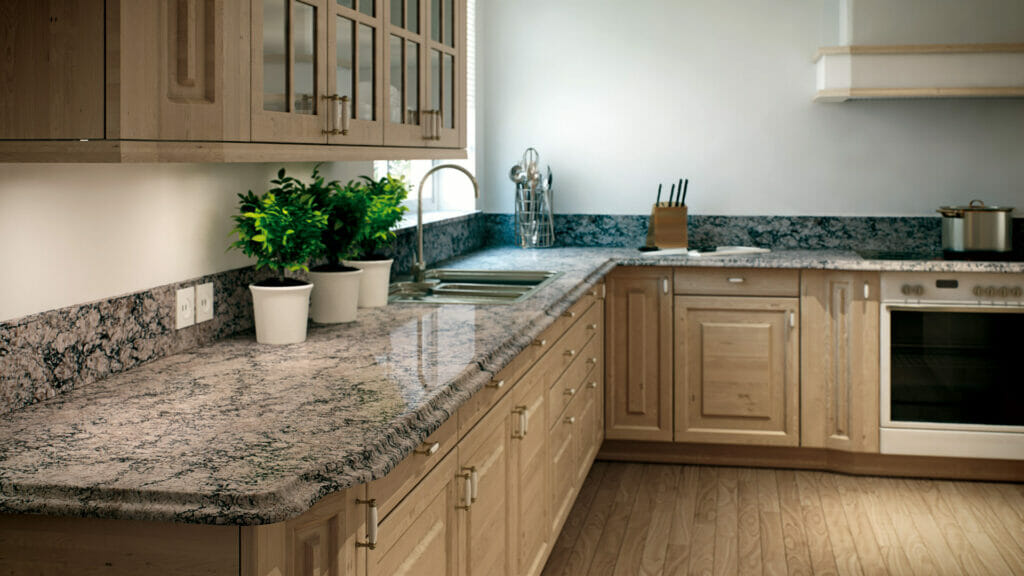 Modern kitchen featuring 6611 Himalayan Moon countertop with dark veining, complemented by light wood cabinetry and plants.