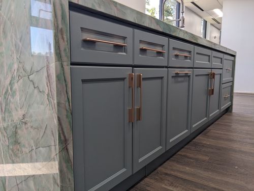 Sage cabinets by J&K, featuring solid wood construction and elegant grey finish with modern hardware.