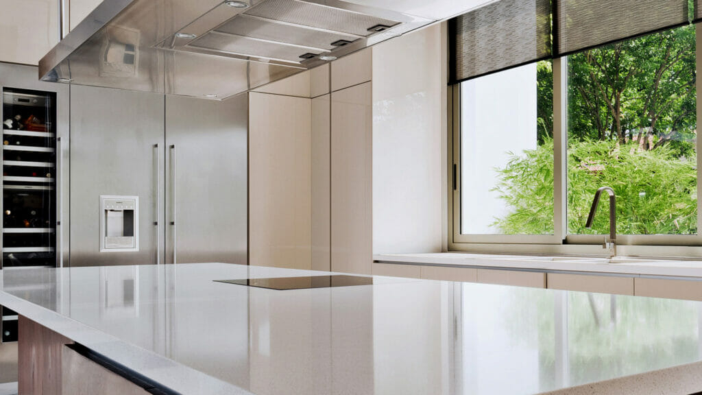 Modern kitchen featuring a sleek white countertop and large windows that flood the space with natural light.