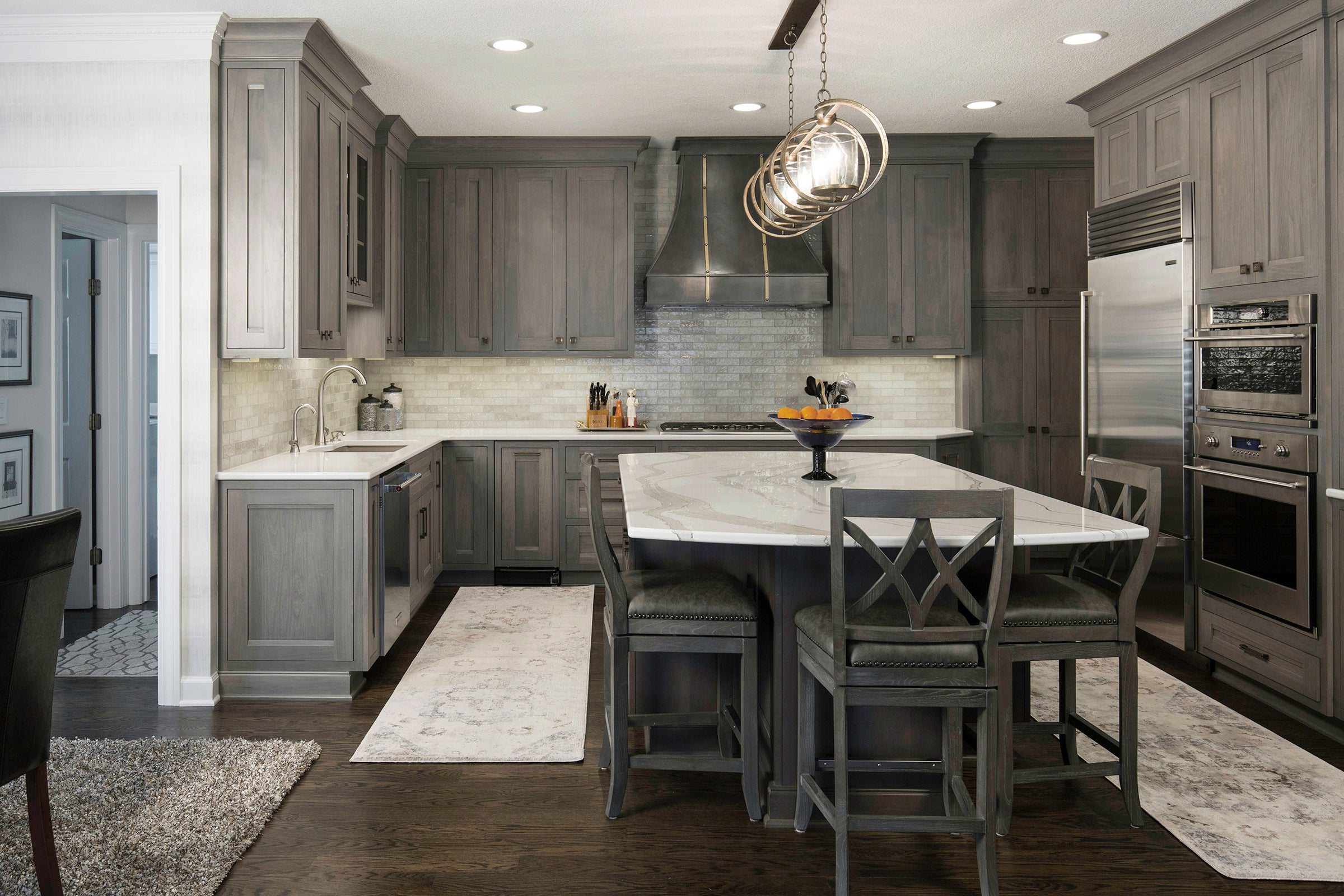 Modern kitchen showcasing Shiloh cabinets in gray tones with a spacious island and stylish decor.