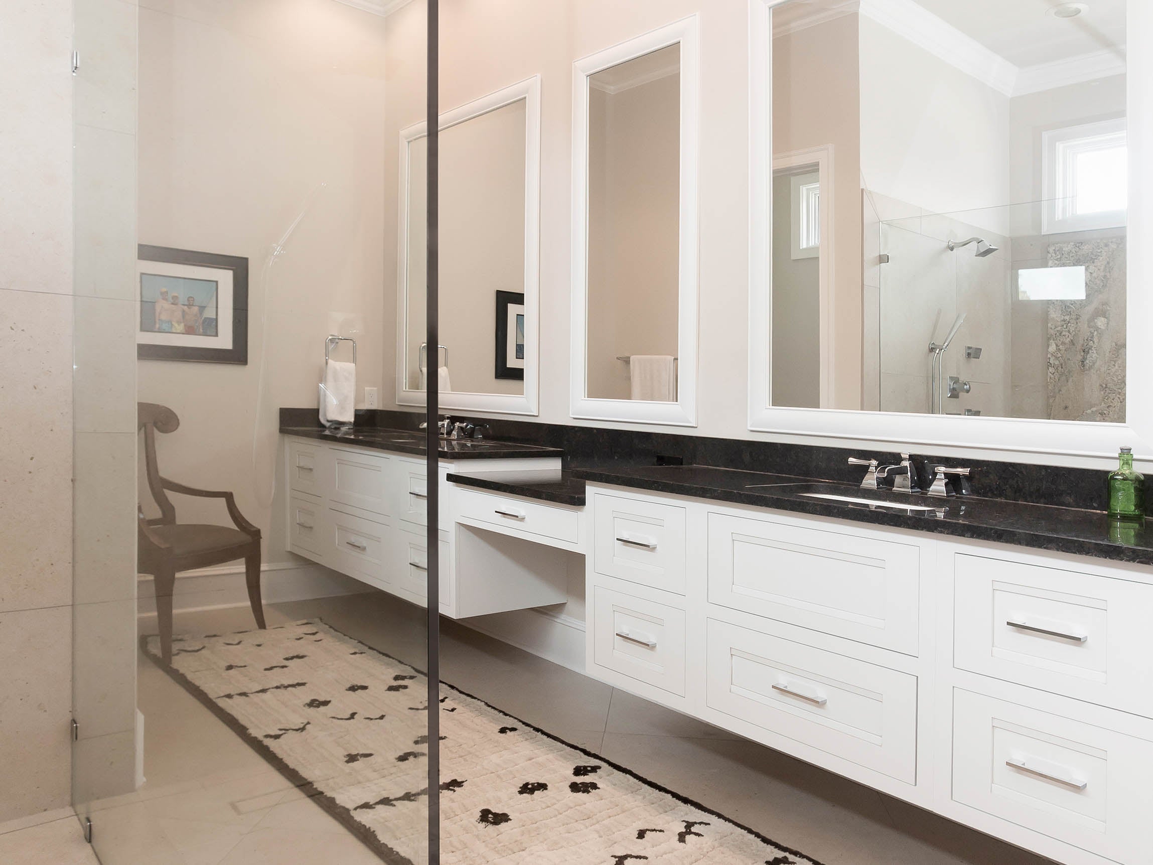 Modern bathroom design featuring white Shiloh cabinets, double mirrors, and sleek fixtures on stylish stone countertop.