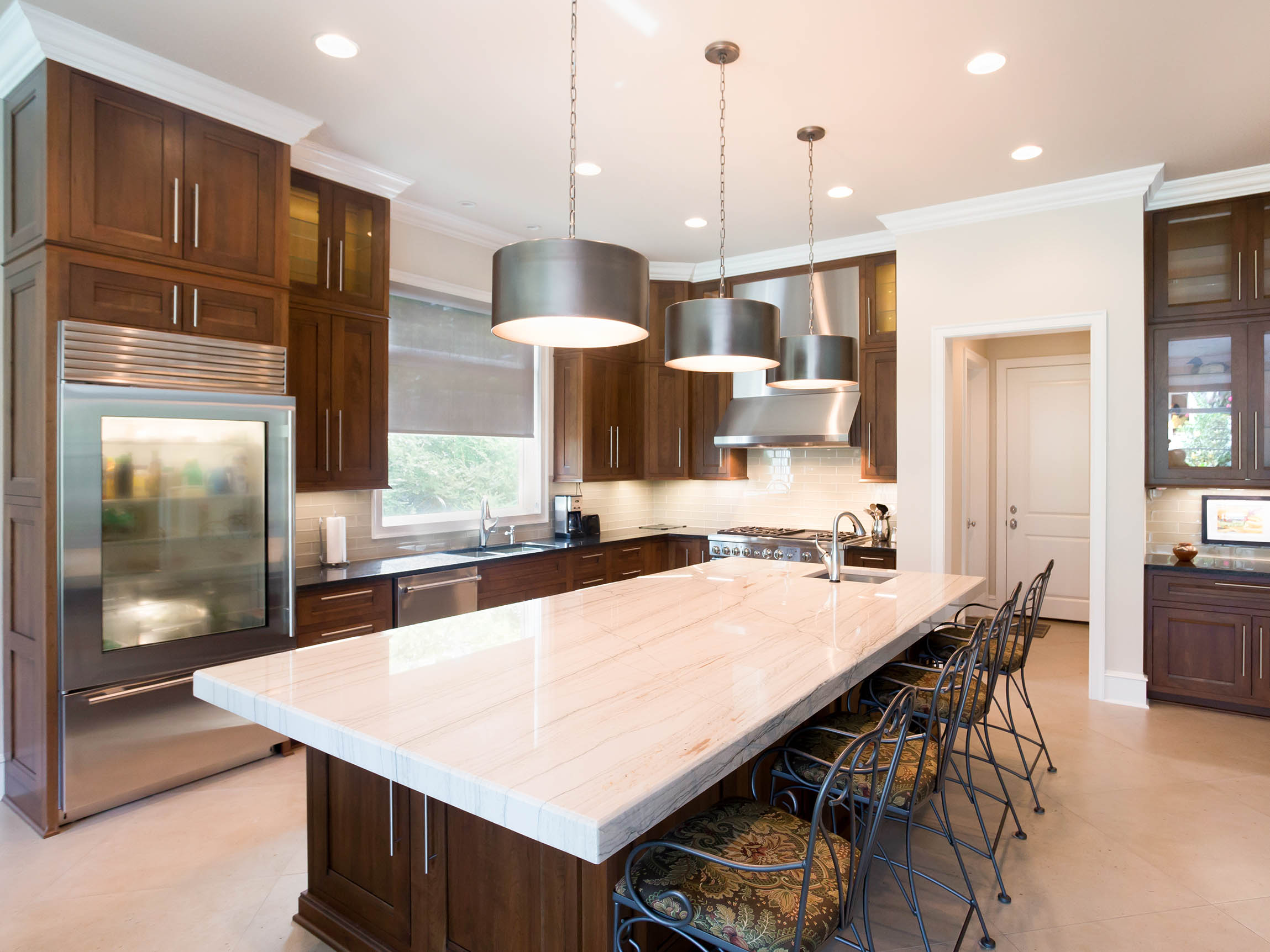 Modern kitchen featuring customizable Shiloh cabinets in rich wood finish with a spacious island and stylish pendant lighting.