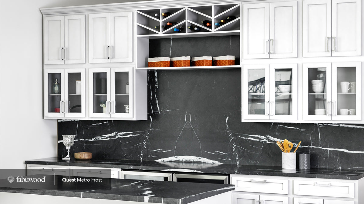 Modern Quest Metro Frost kitchen cabinets with elegant glass doors and stylish black marble countertop.