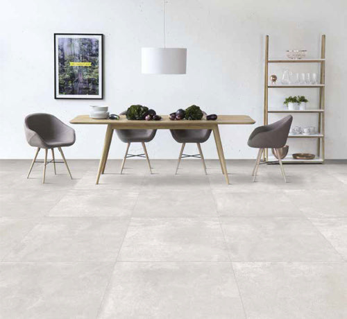 Modern dining area with Apollo Pearl Matt tiles, featuring a wooden table and stylish chairs, complemented by minimalist decor.