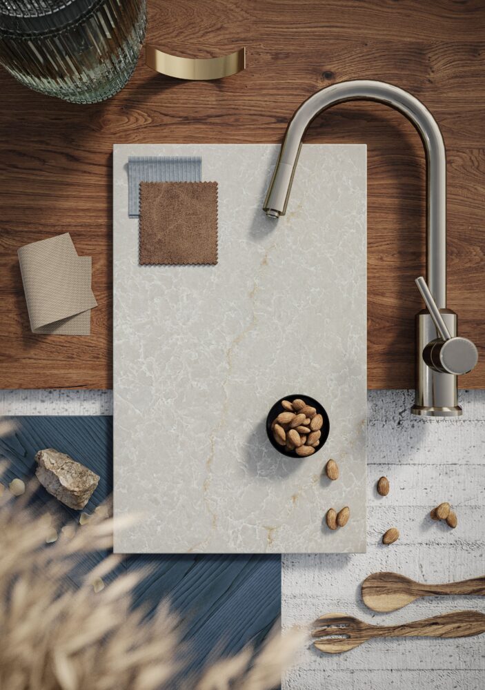 5310 Brillianza countertop with frosty white veins, gray base, and warm peach accents styled with kitchen accessories.