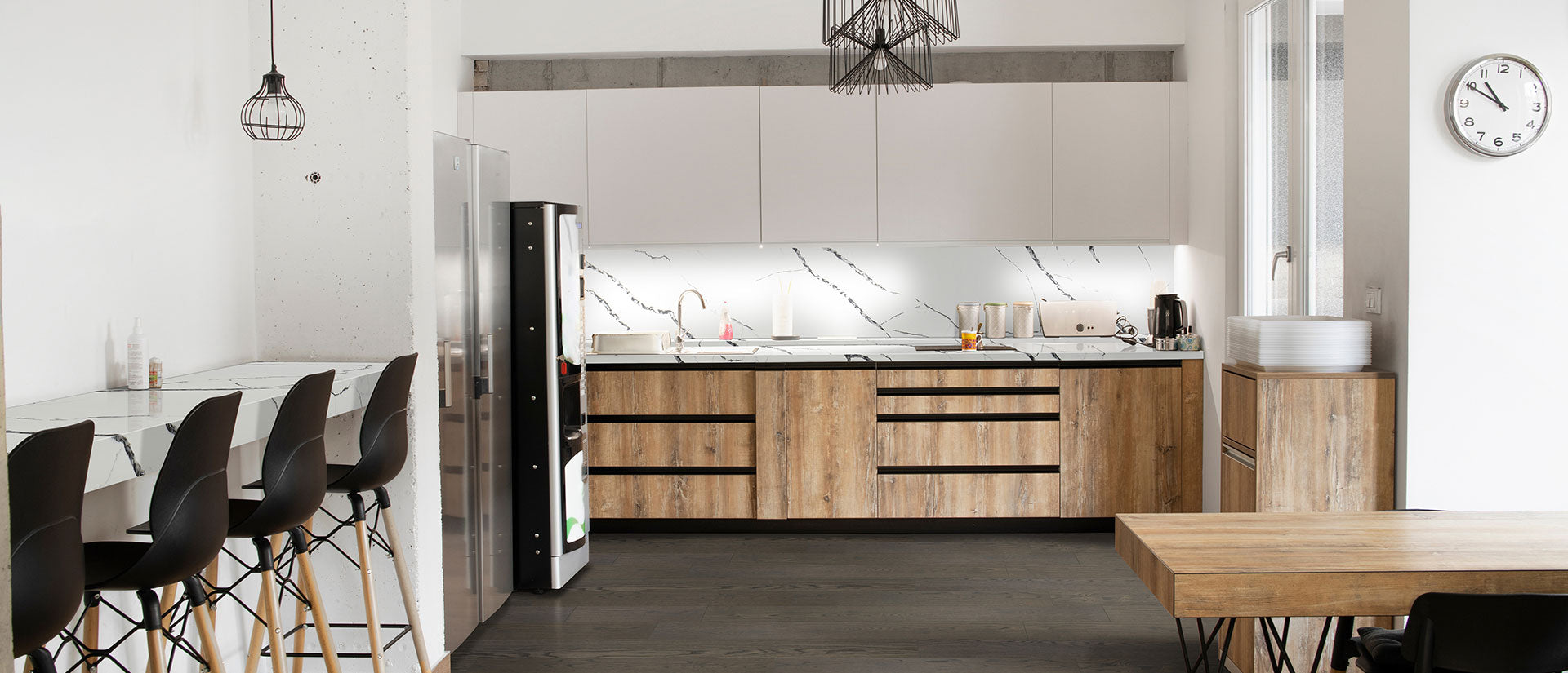 A luxury kitchen featuring Calacatta Laza Night quartz countertops with bold white veining on a deep charcoal-black polished surface, showcasing a modern mitered edge.