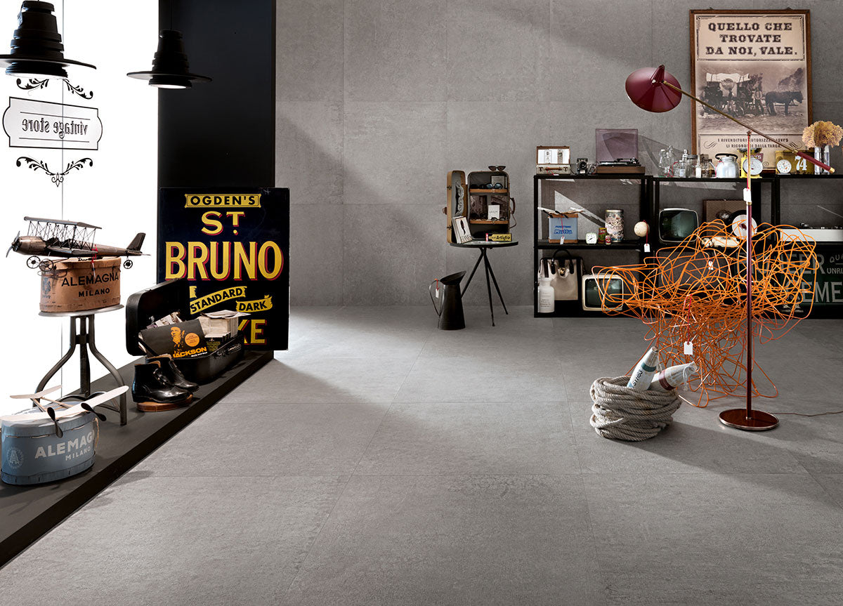 Modern indoor space featuring Concerto Grigio porcelain tiles with vintage decor elements and industrial design accents.