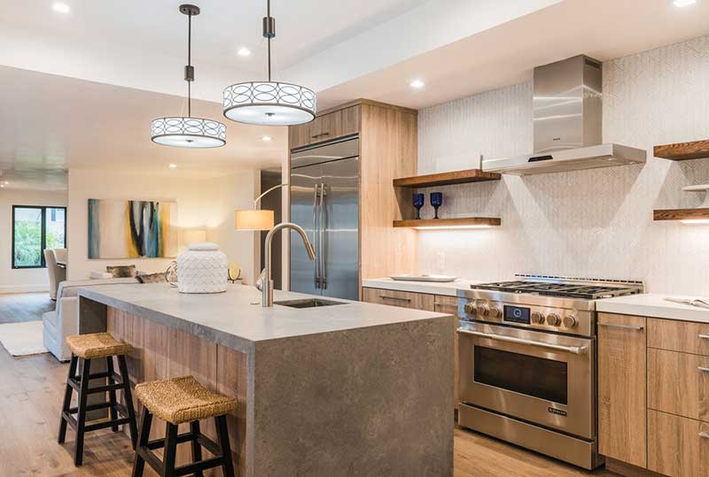 Modern kitchen featuring 4033 Rugged Concrete island with textured finish and industrial design elements.
