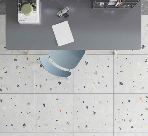 Terrazzo Bianco Matt Tile displayed under a modern desk with a blue chair and decorative items.