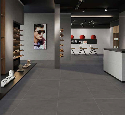 Modern retail space featuring Wicky Nero Matt tiles, showcasing a stylish design with eyewear displays.
