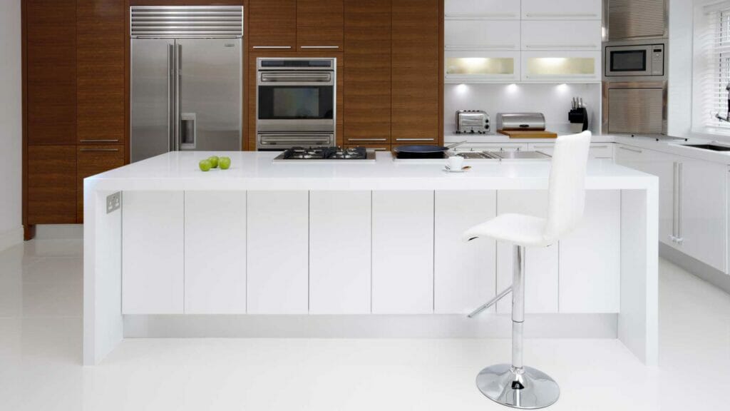 Modern kitchen featuring a white island, stainless steel appliances, and wooden cabinetry for a sleek design.