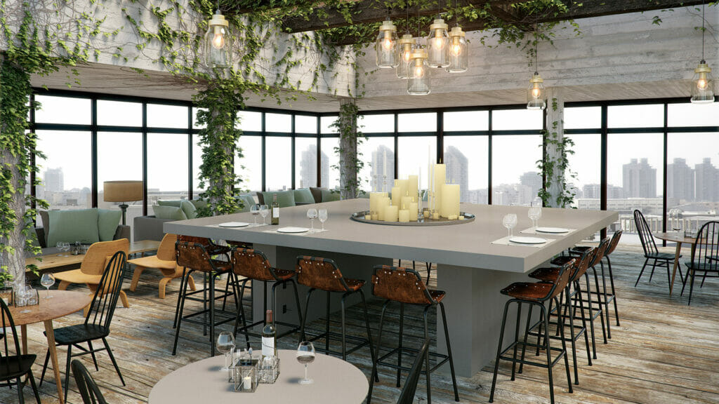Stylish urban dining area featuring a concrete table, cozy seating, and large windows with city views.
