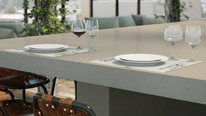 Modern dining setup featuring a 4004 Raw Concrete table with plates and wine glasses, showcasing urban aesthetics.
