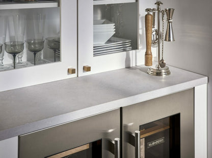 Close-up of a modern kitchen countertop featuring 4044 Airy Concrete with refined texture and elegant kitchen accessories.