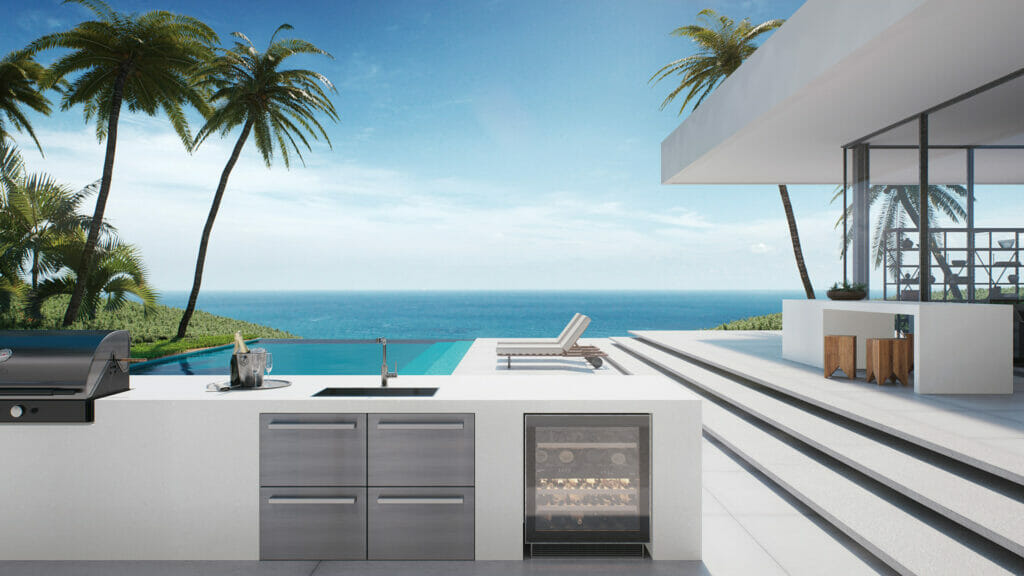 Modern outdoor kitchen with a stunning ocean view, featuring a grill and sleek cabinetry, surrounded by palm trees.
