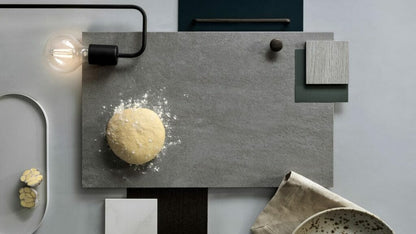 Top view of a modern kitchen surface with a dough ball, showcasing a grey concrete aesthetic in Ultra Rough finish.