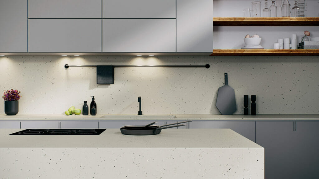 Modern kitchen with neutral terrazzo-style countertop featuring black basalt and greys, complemented by sleek cabinetry.