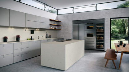 Modern kitchen featuring 4601 Frozen Terra concrete island with a neutral palette and terrazzo-inspired design.