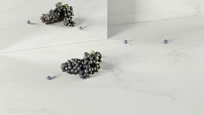 Beautiful pure white surface resembling marble with delicate golden-brown veining, featuring grapes and decorative elements.