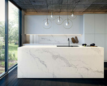 Statuario Maximus kitchen island featuring dove-white surface with light-grey veins, modern design, and natural light.