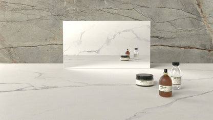 Grey and white marble surface with decorative jars, reflecting mirror, showcasing natural textures.