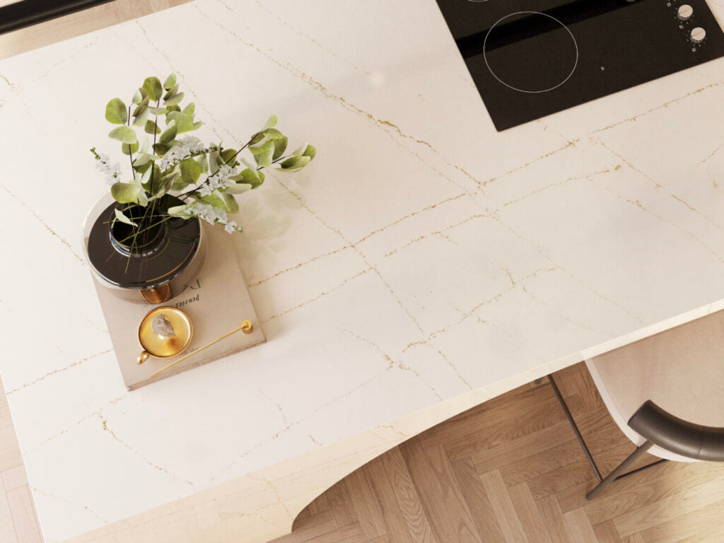 Elegant white countertop with bronze veins, adorned with a plant and kitchenware, showcasing a modern aesthetic.