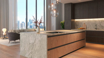 Modern kitchen featuring a sleek oversized marble island with wooden cabinetry and stunning city views.
